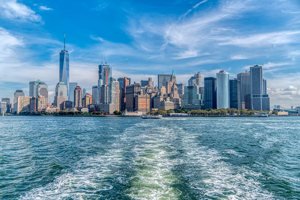 city skyline across body of water under blue_yythkg.jpg